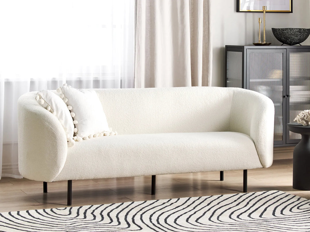 White bouclé three seater sofa with soft textured upholstery
