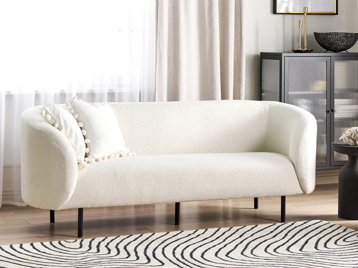 White bouclé three seater sofa with soft textured upholstery
