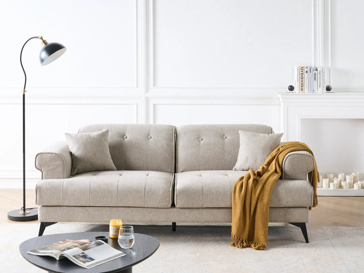 Beige sofa with a yellow blanket in a modern living room setting.