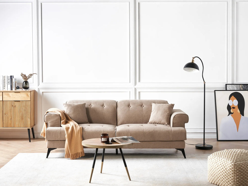 Modern living room with a beige sofa, coffee table, and decorative items.