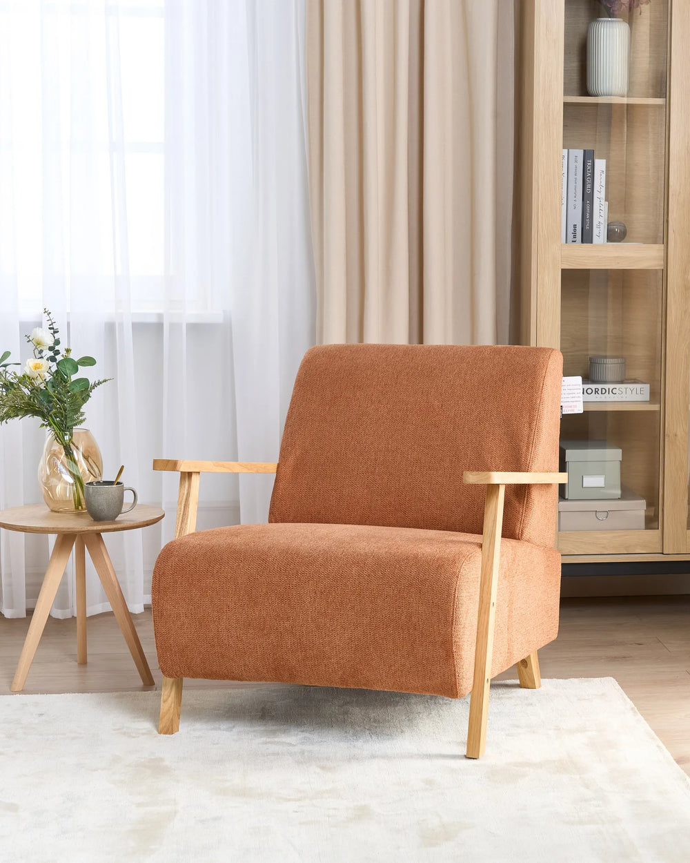 Upholstered in rich orange fabric, this armchair combines contemporary design with inviting comfort.