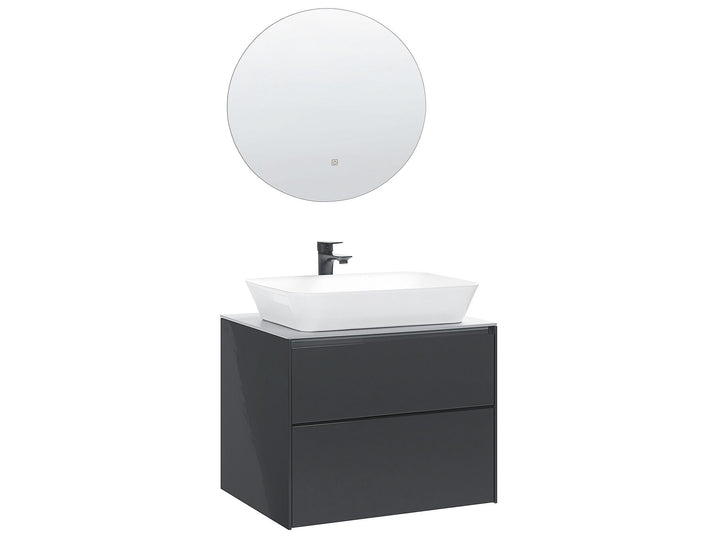 Bathroom vanity with white sink and round mirror on a white background