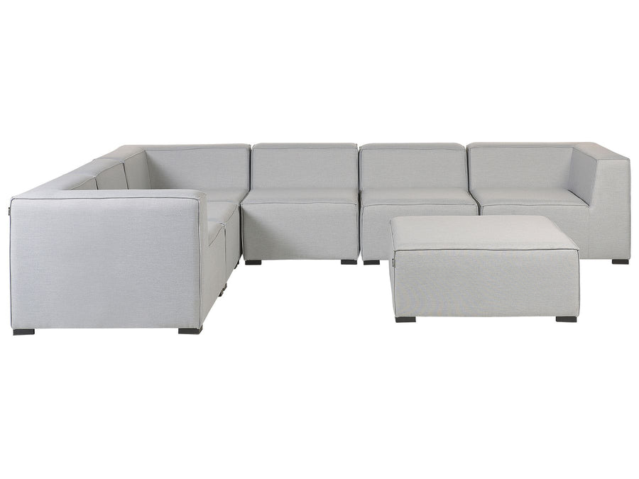 Gray sectional sofa with ottoman on a white background