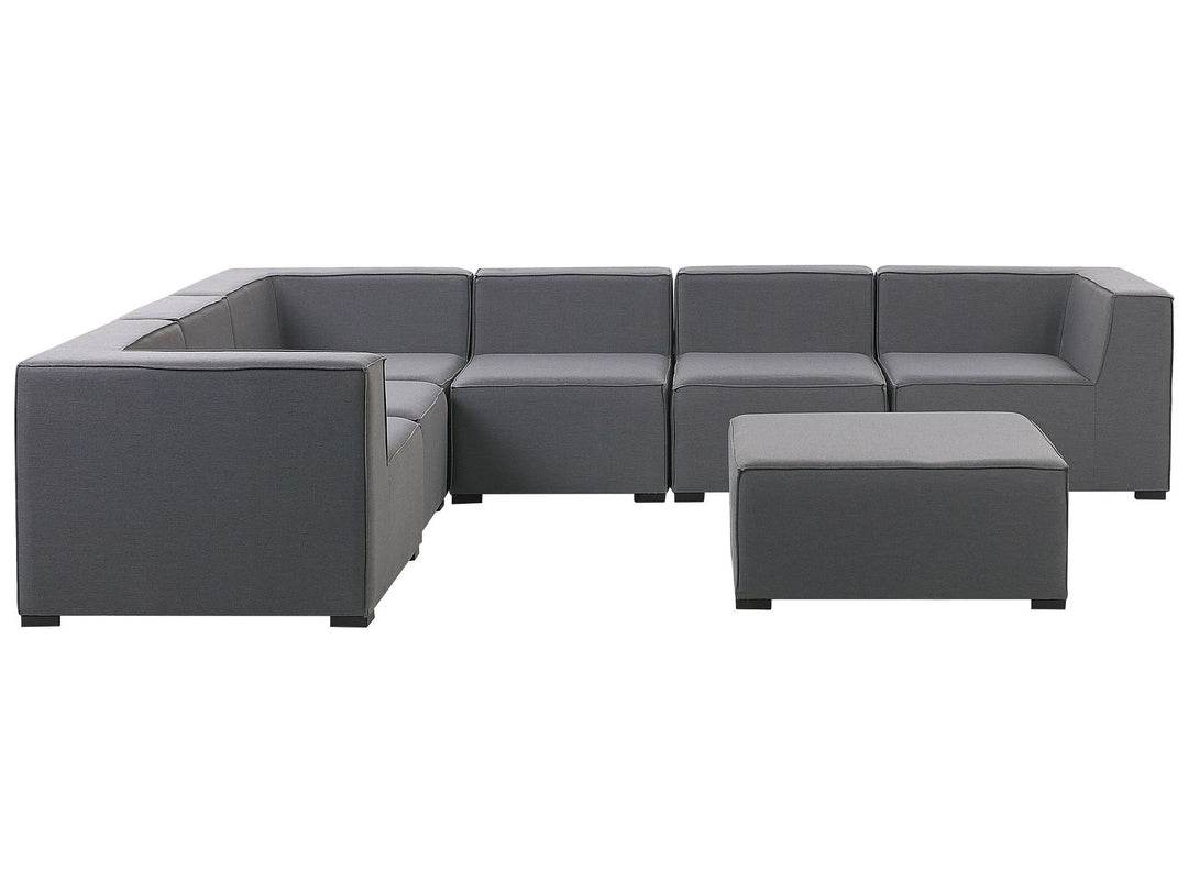 Gray sectional sofa with ottoman on a white background