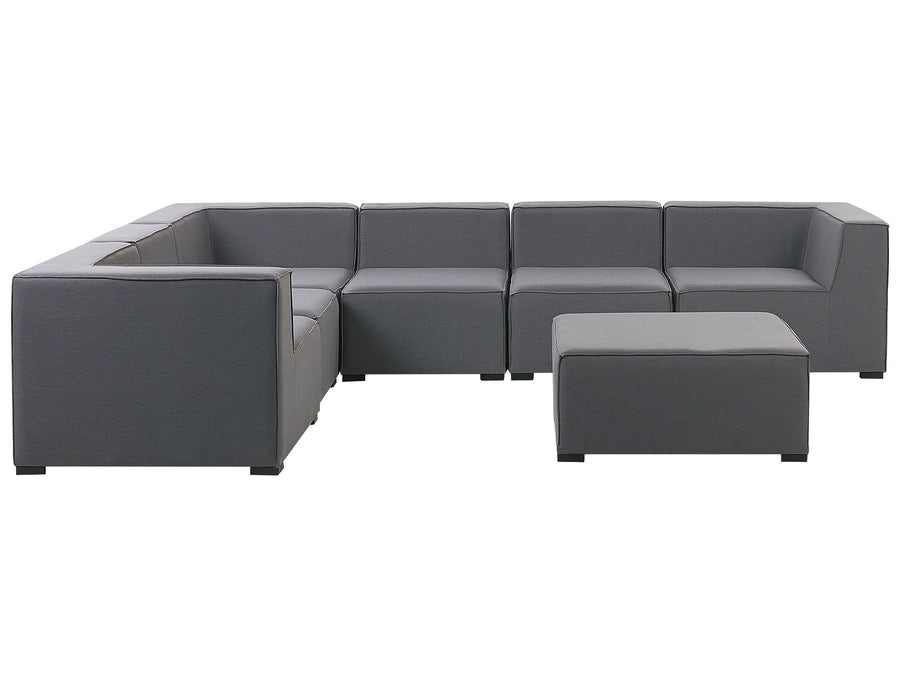 Gray sectional sofa with ottoman on a white background