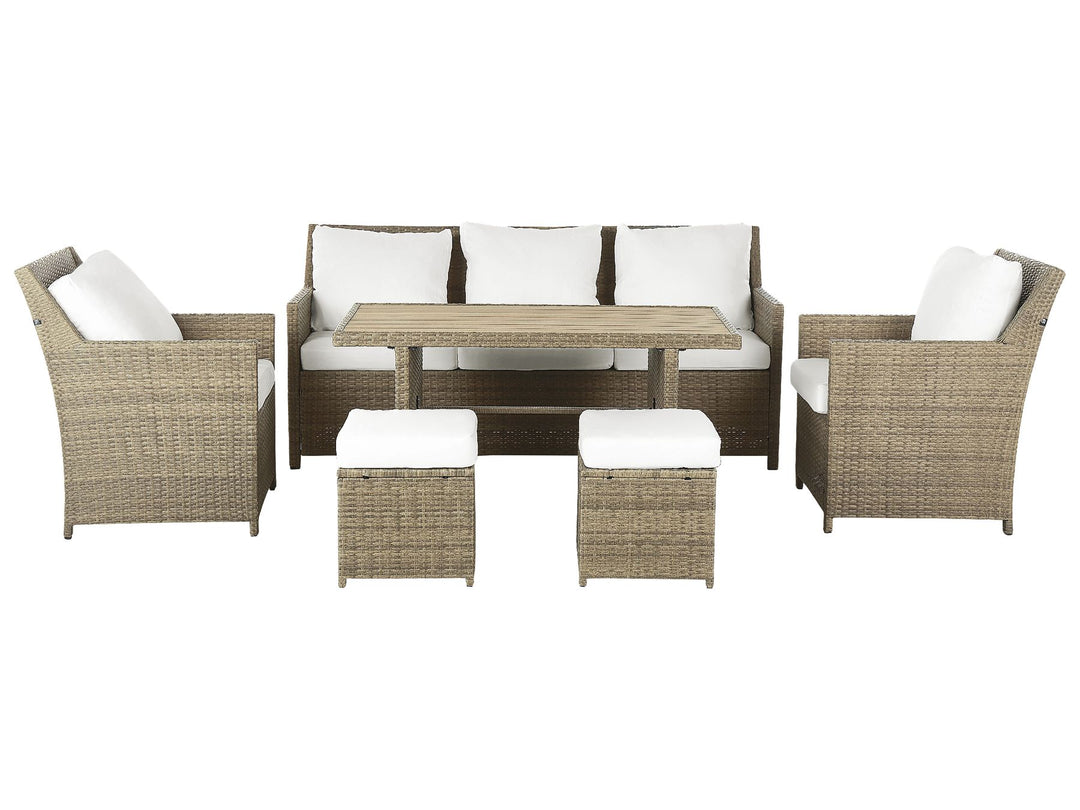 Outdoor furniture set with wicker chairs, table, and ottomans on a white background