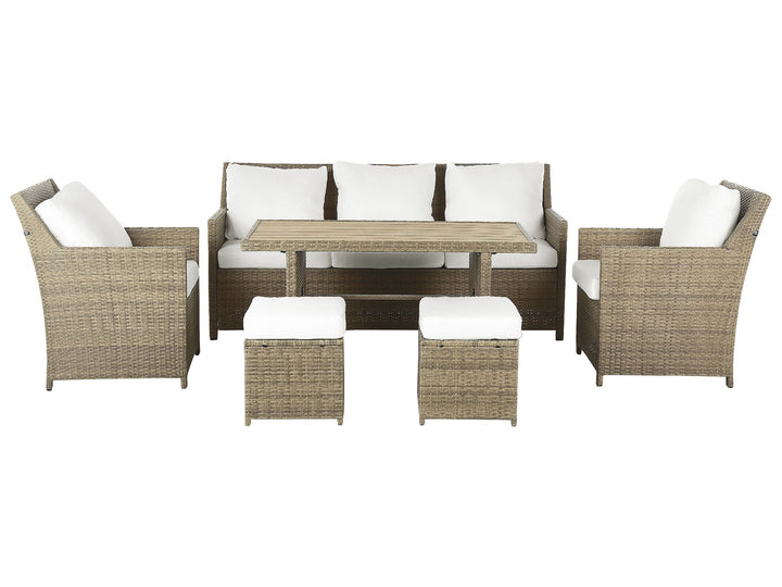 Outdoor furniture set with wicker chairs, table, and ottomans on a white background