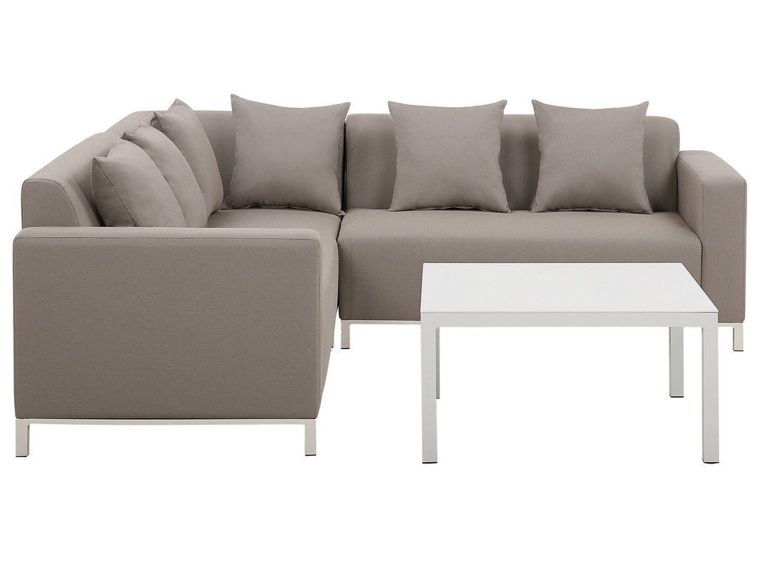 Beige sectional sofa with cushions and a coffee table on a white background
