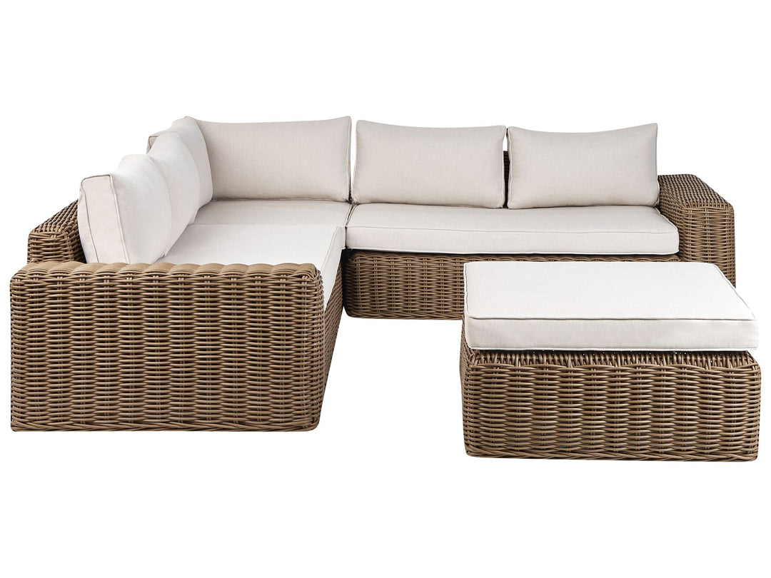 Wicker outdoor sectional with white cushions on a white background