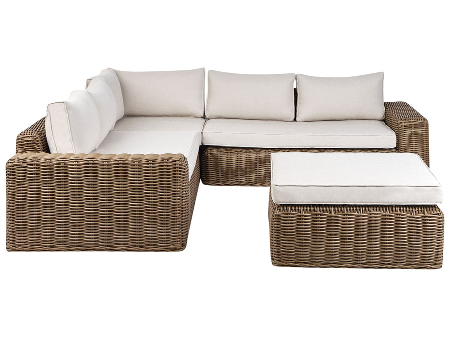 Wicker outdoor sectional with white cushions on a white background