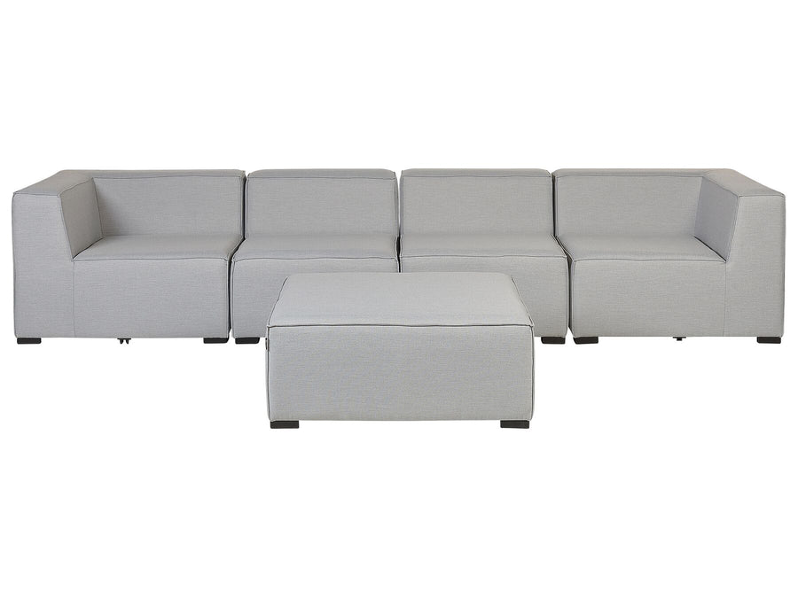 Gray sectional sofa with ottoman on a white background