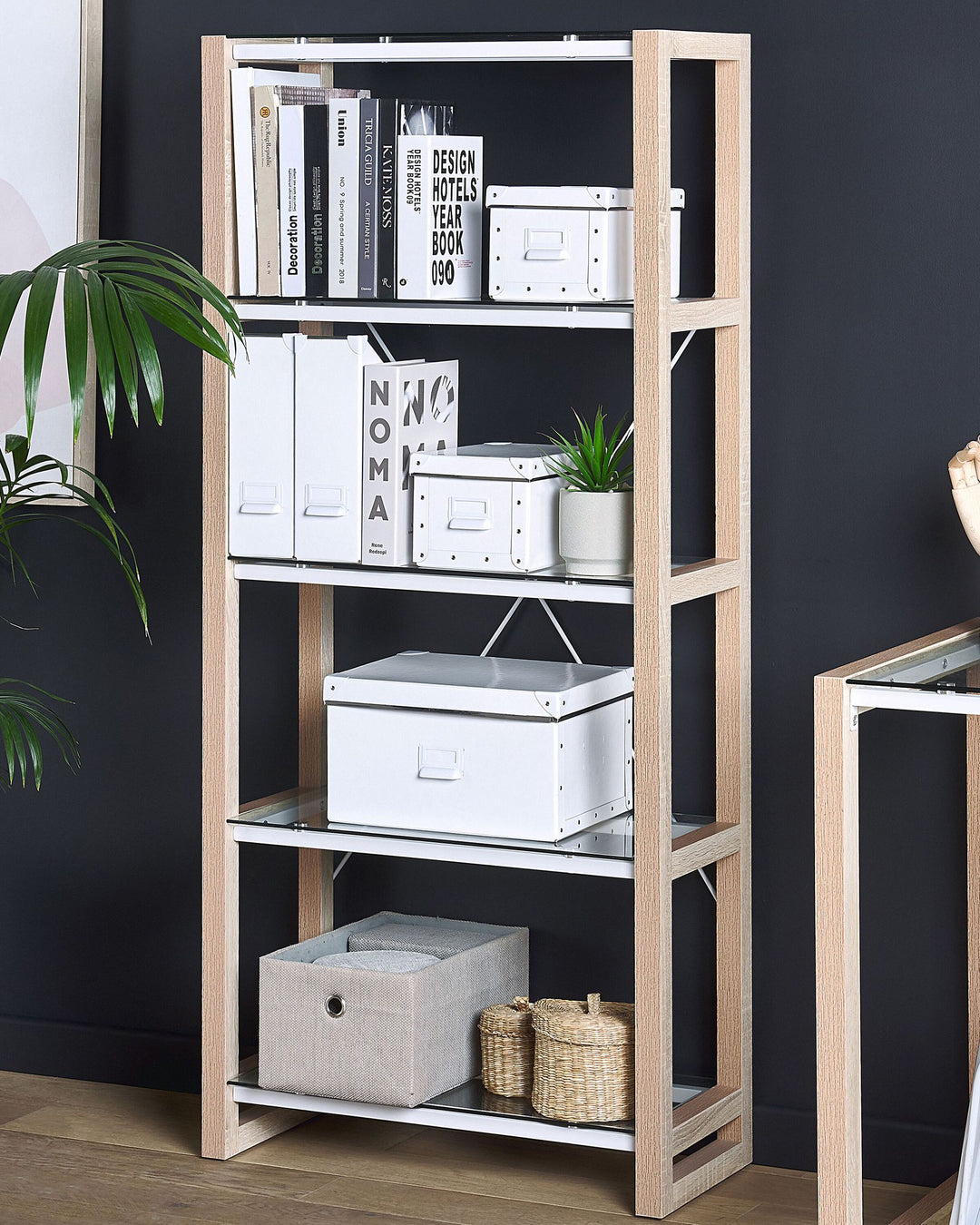 Wooden bookshelf with books, boxes, and decorative items against a dark wall.