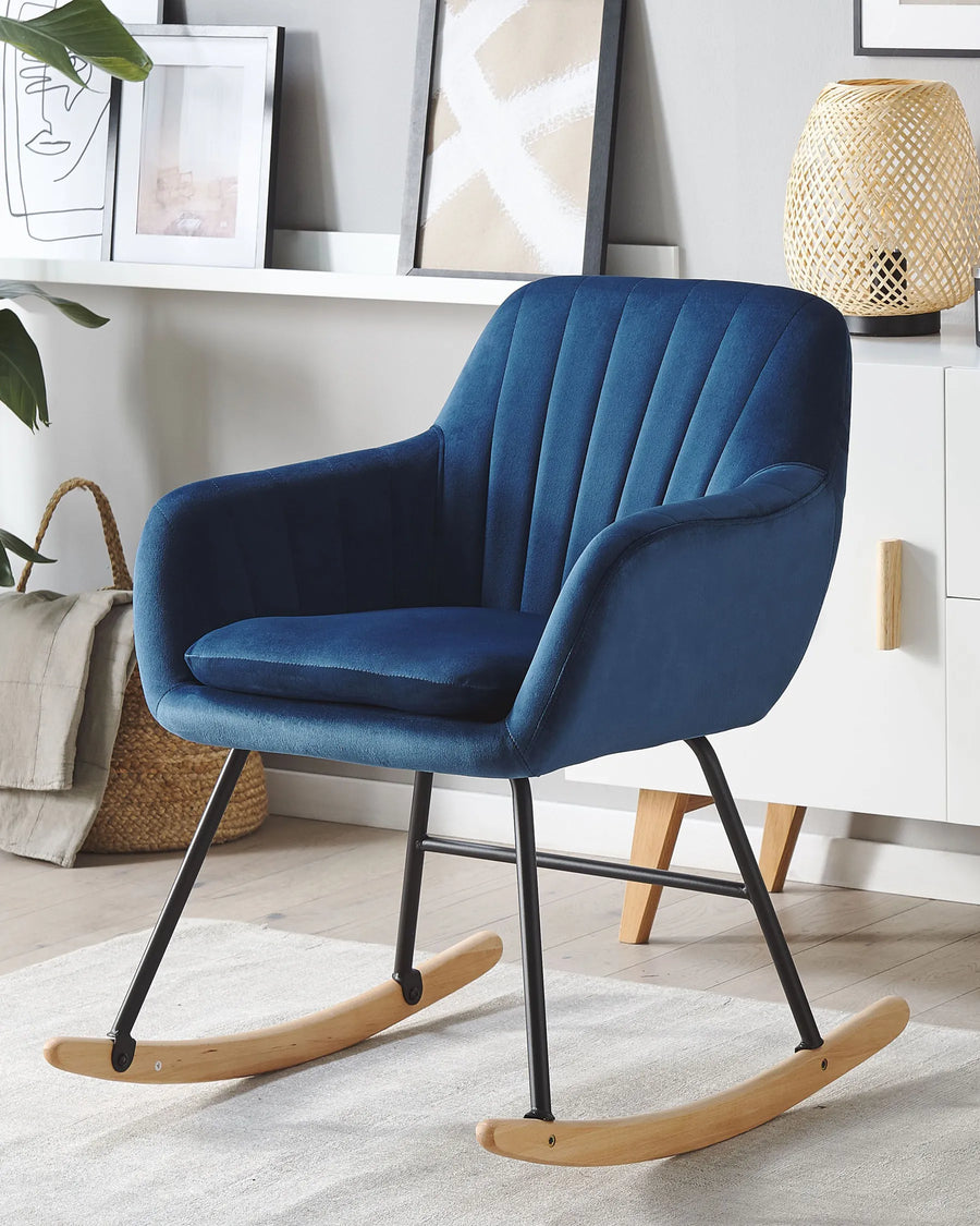 Blue rocking chair in a room with white walls and decor