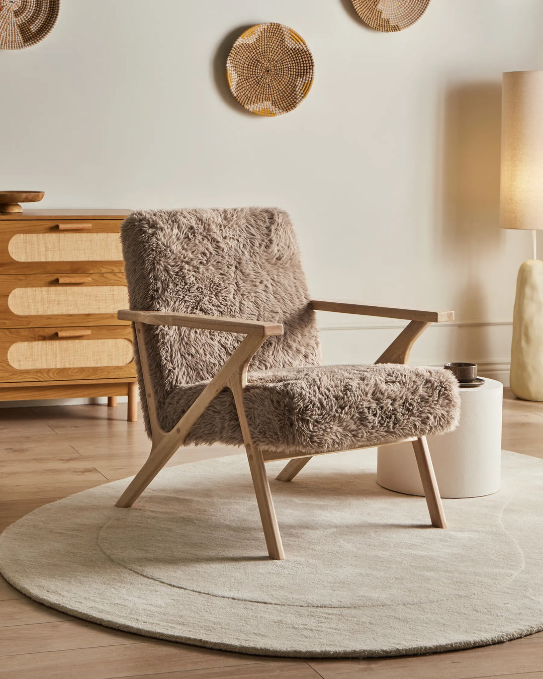 Cozy armchair with fluffy cushion in a warm-toned room.