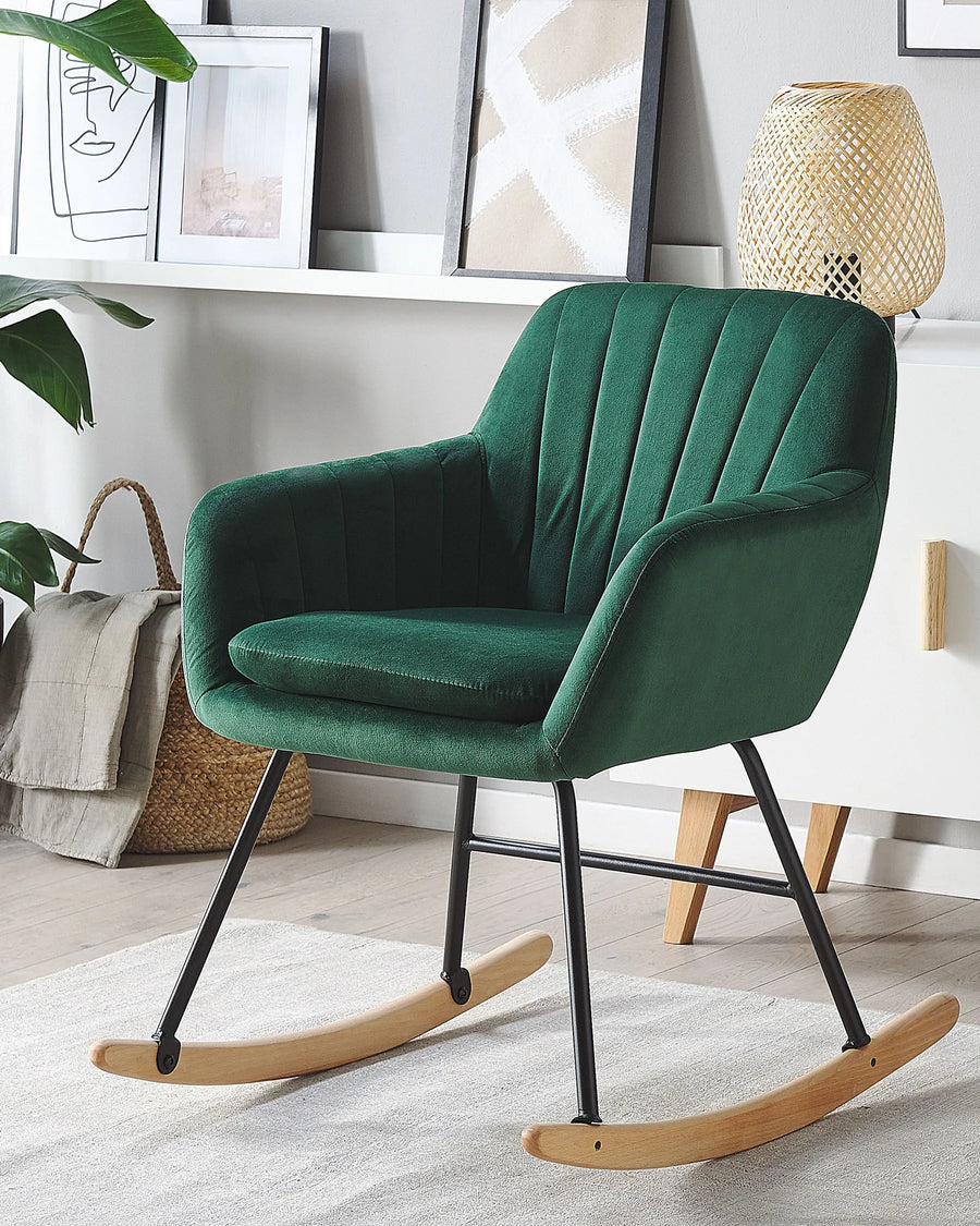 Green rocking chair in a room with decor elements.