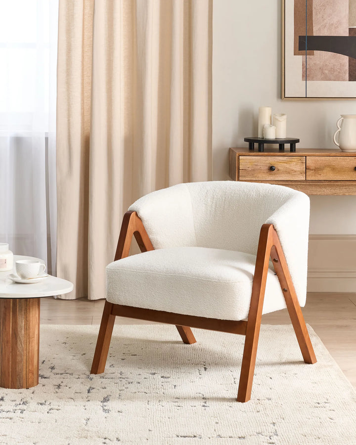 White armchair with wooden frame in a living room setting