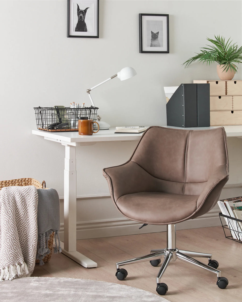 Brown office chair in front of a white desk with office supplies in a home office setting.