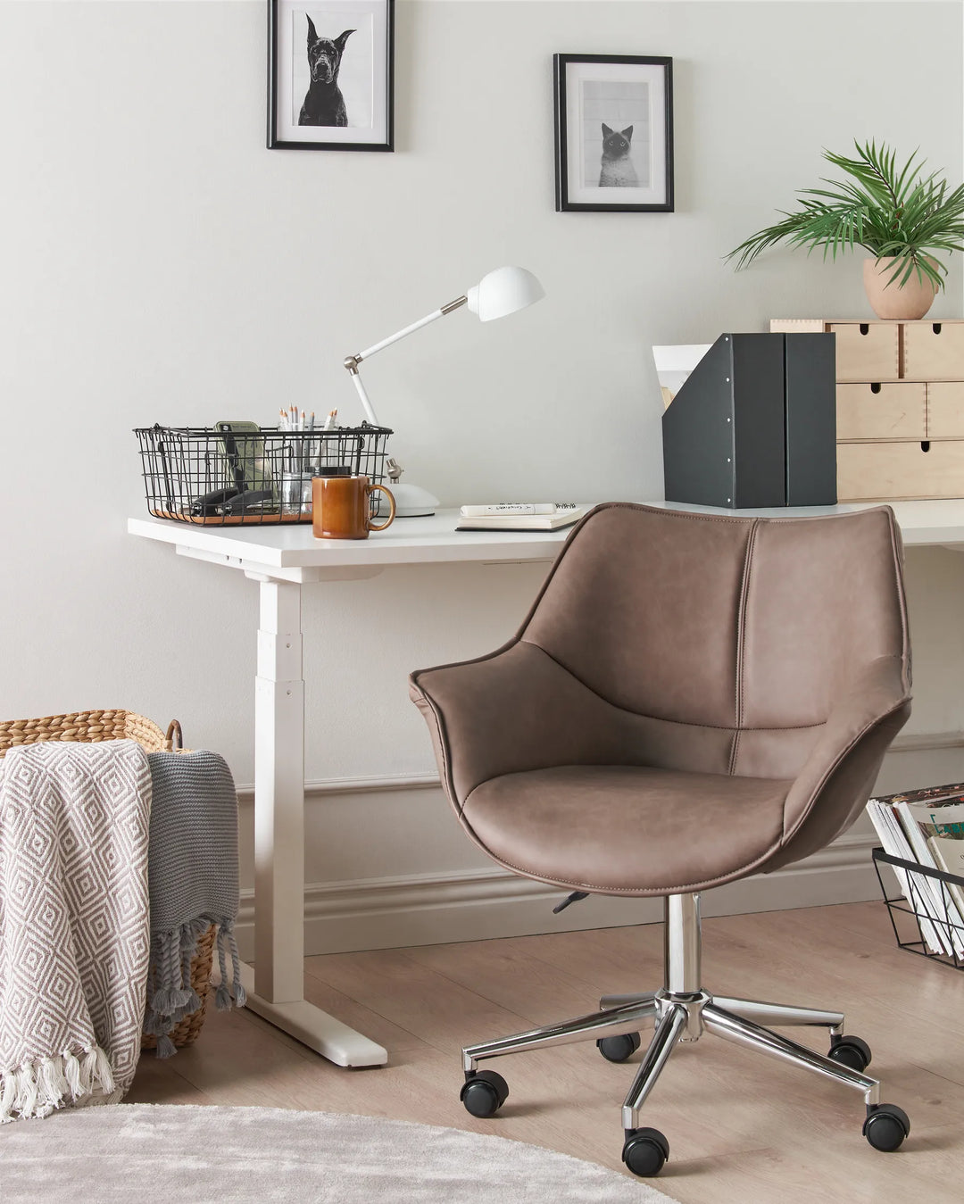 Brown office chair in front of a white desk with office supplies in a home office setting.