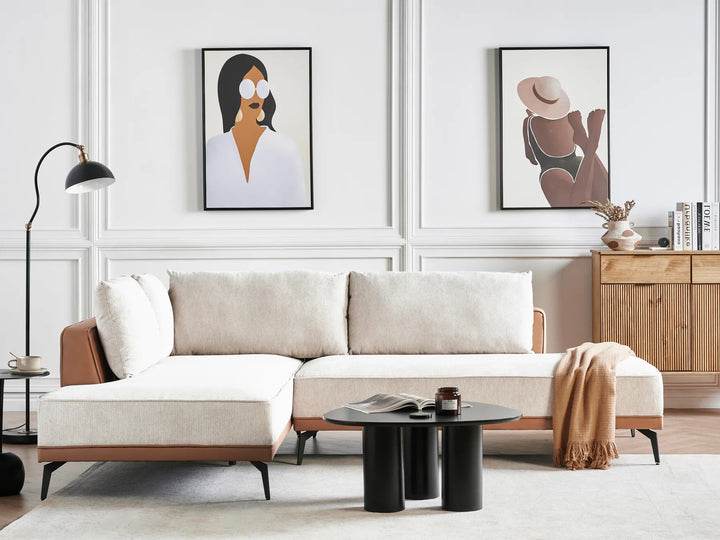 Modern living room with a beige sectional sofa, wooden cabinet, and wall art.
