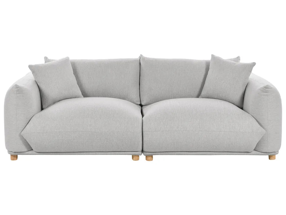 Gray sofa with four cushions on a white background