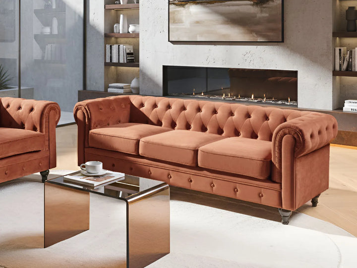 Living room with a brown Chesterfield sofa, coffee table, and fireplace.