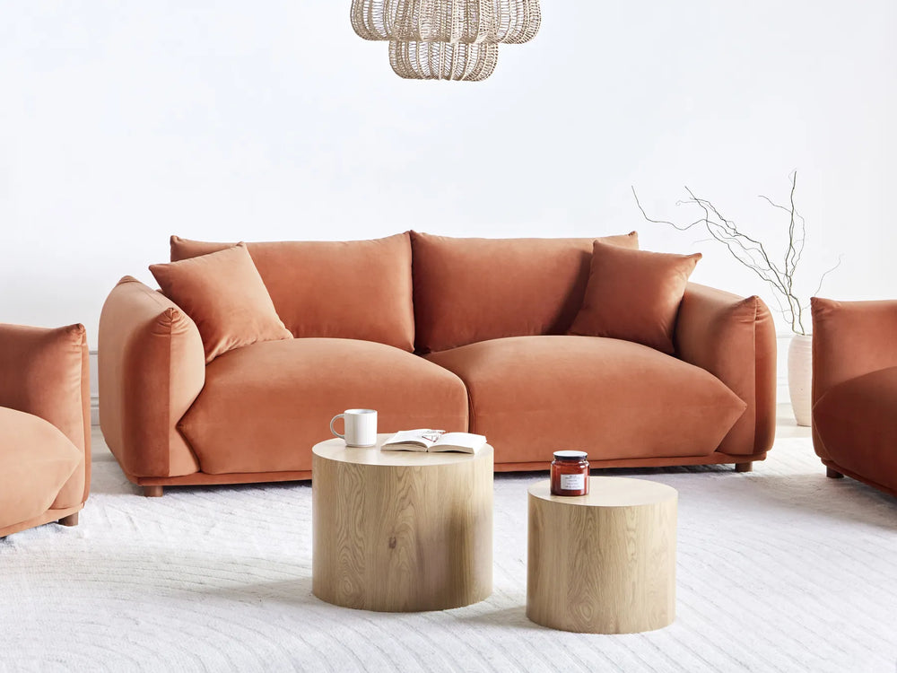 Modern living room with a brown sofa and wooden coffee tables.