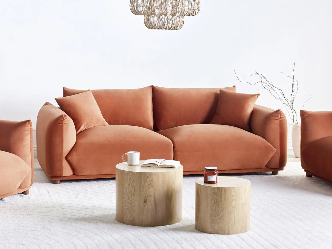 Modern living room with a brown sofa and wooden coffee tables.