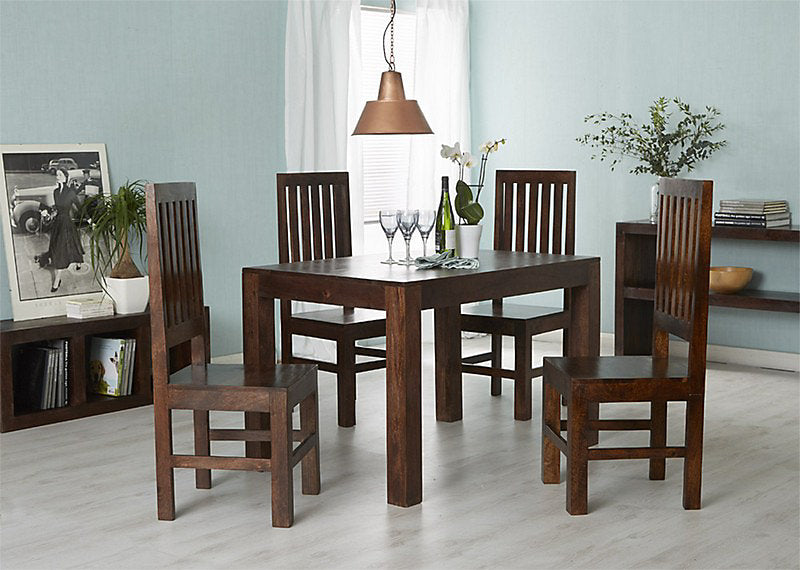 Dining room with wooden table and chairs, wine glasses, and a bottle.