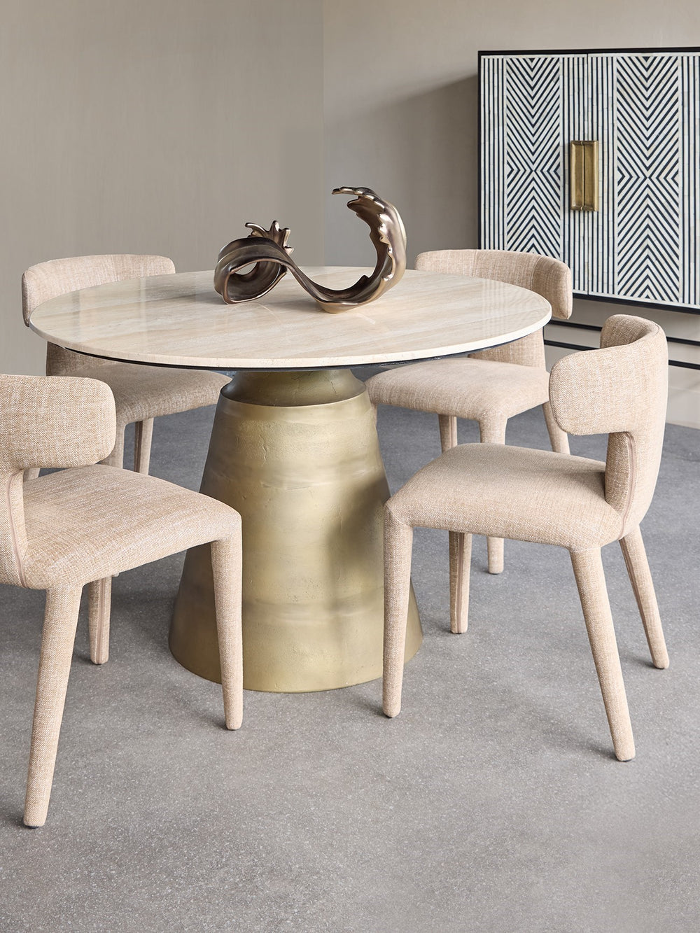 Dining table with marble top and gold base in a modern room setting