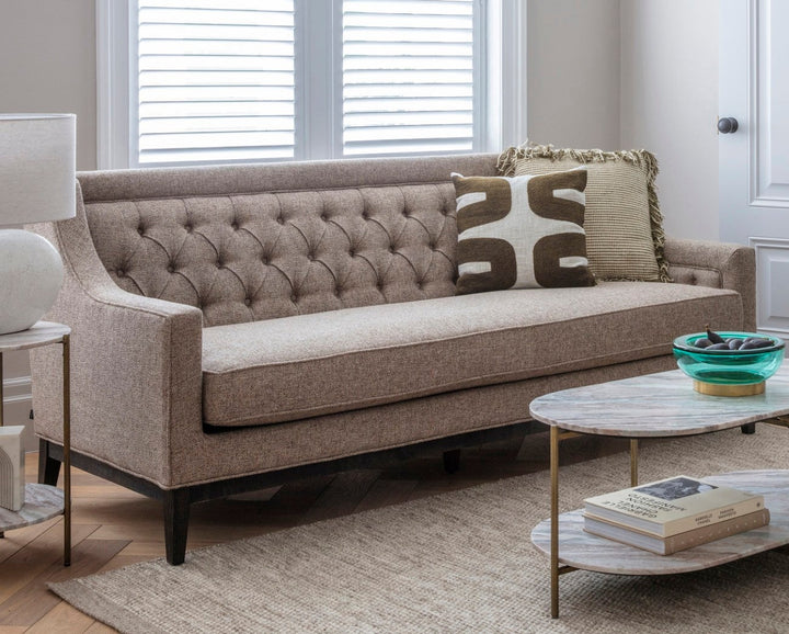 Brown sofa in a living room with a coffee table and decorative items.
