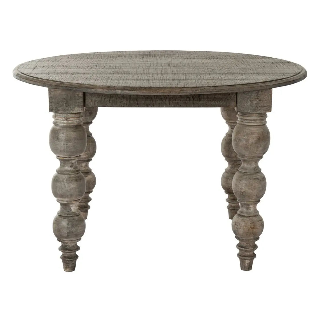 Round wooden dining table with turned legs on a white background