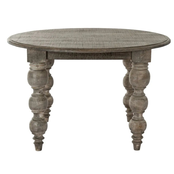 Round wooden dining table with turned legs on a white background