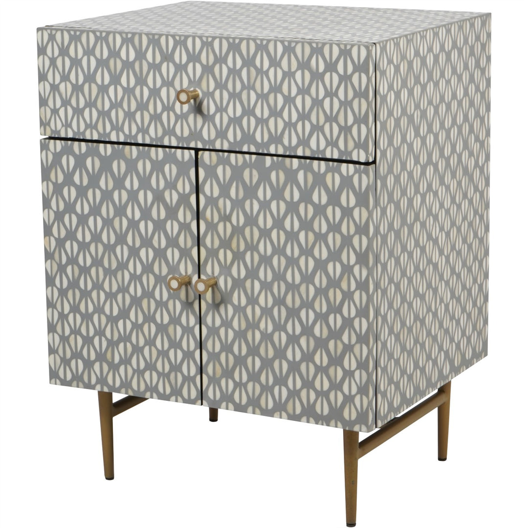 Patterned cabinet with gold legs on a white background
