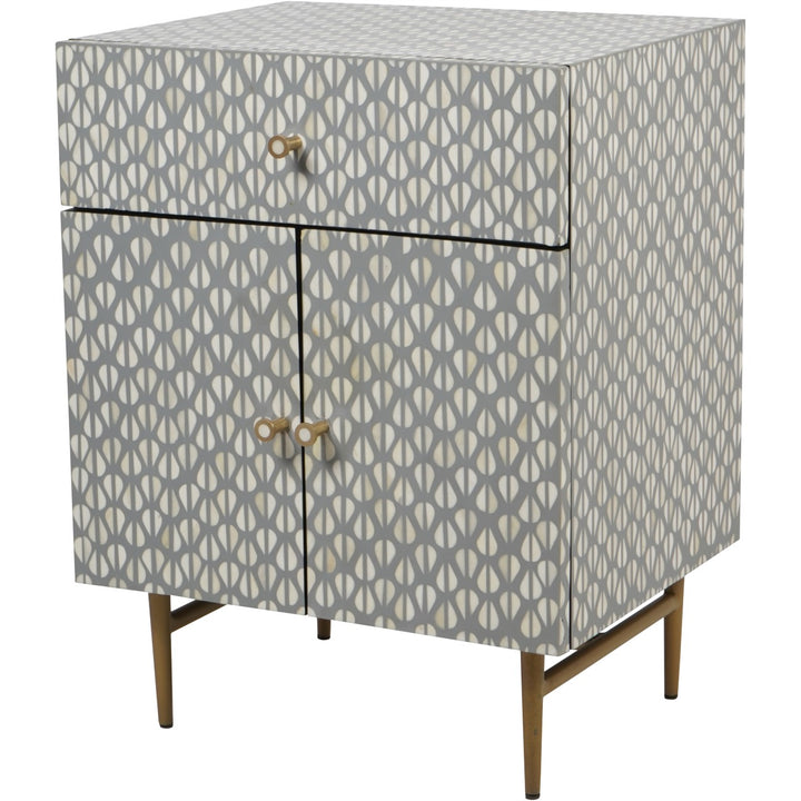 Patterned cabinet with gold legs on a white background