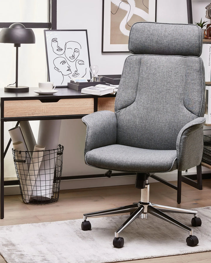 Gray office chair in a modern office setting with a desk and decor.