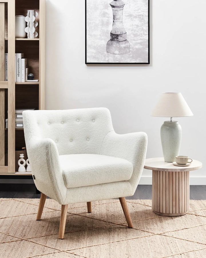 White armchair with wooden legs on a white background