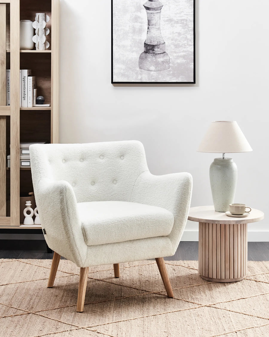 White armchair with wooden legs on a white background
