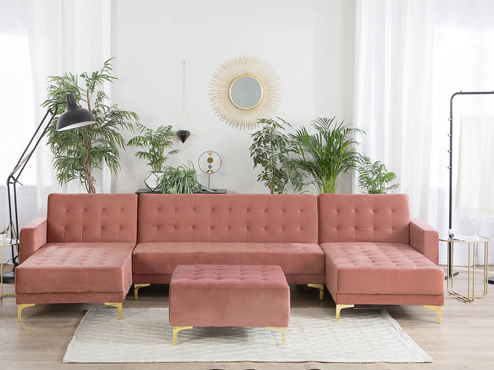 Denby pink velvet U‑shape sectional sofa with ottoman and tufted upholstery