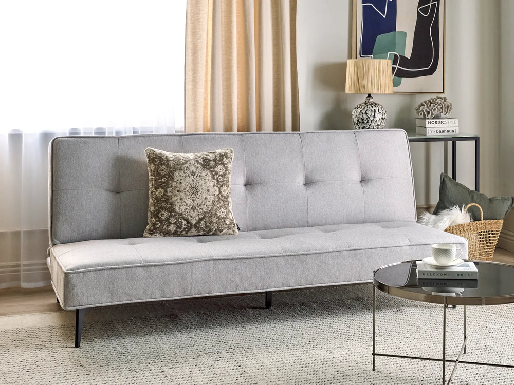 Gray sofa with a decorative pillow in a living room setting