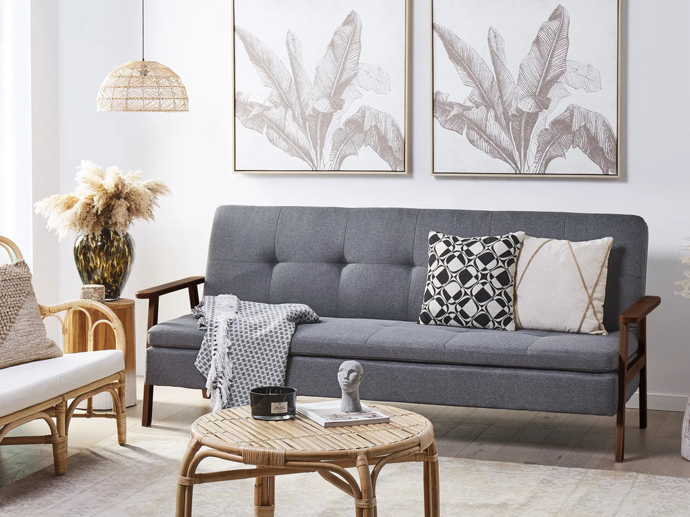 Gray sofa with decorative pillows in a living room setting