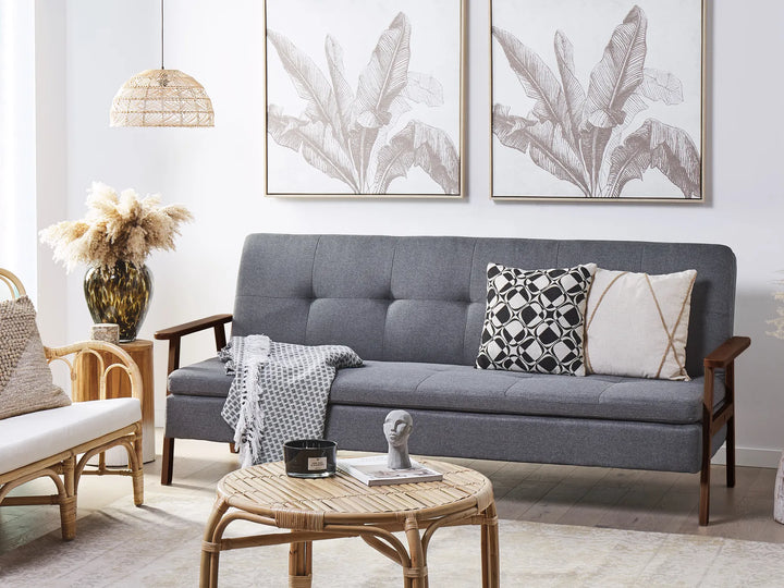Gray sofa with decorative pillows in a living room setting