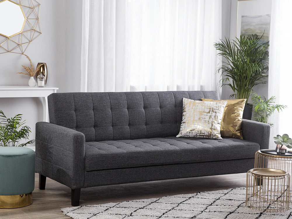 Gray sofa with decorative pillows in a living room setting