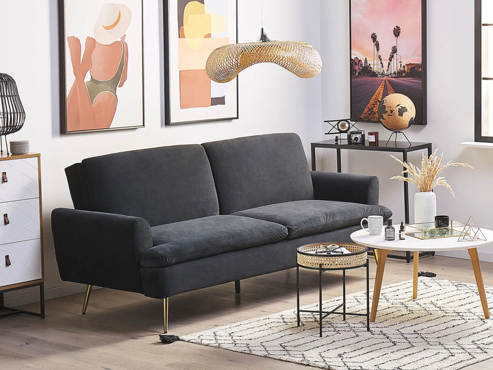 Modern living room with a gray sofa, coffee table, and decorative items.