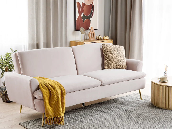 Light gray sofa with a yellow blanket and beige pillow in a living room setting.
