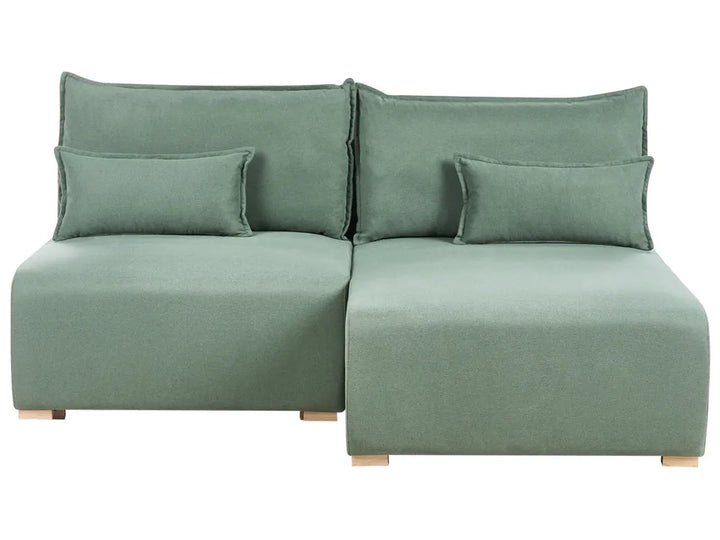 Green sectional sofa with cushions on a white background