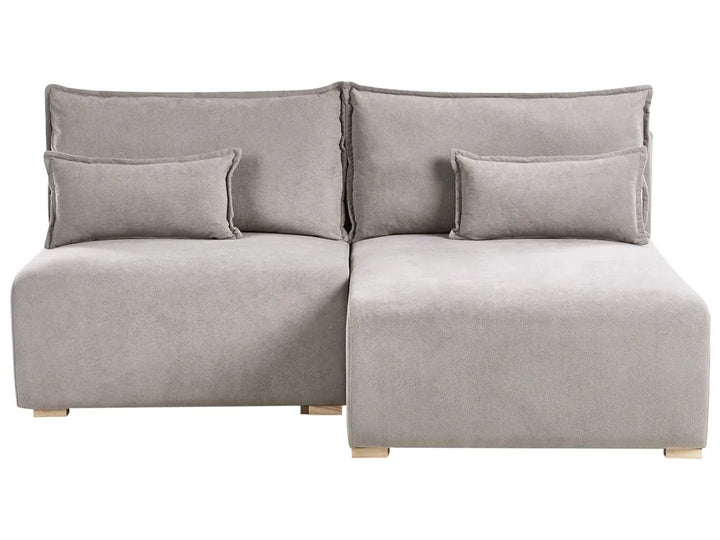 Gray sectional sofa with cushions on a white background