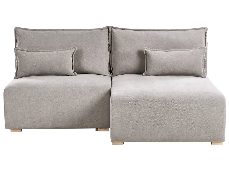 Gray sectional sofa with cushions on a white background