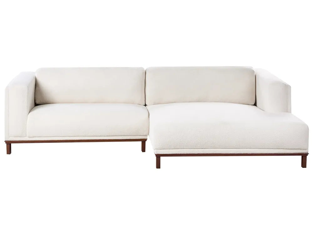 Off-white bouclé left-hand corner sofa with wooden legs and plush cushions, modern L-shaped design