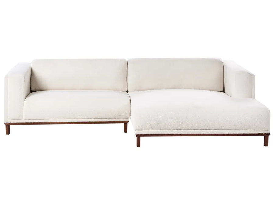 Off-white bouclé left-hand corner sofa with wooden legs and plush cushions, modern L-shaped design
