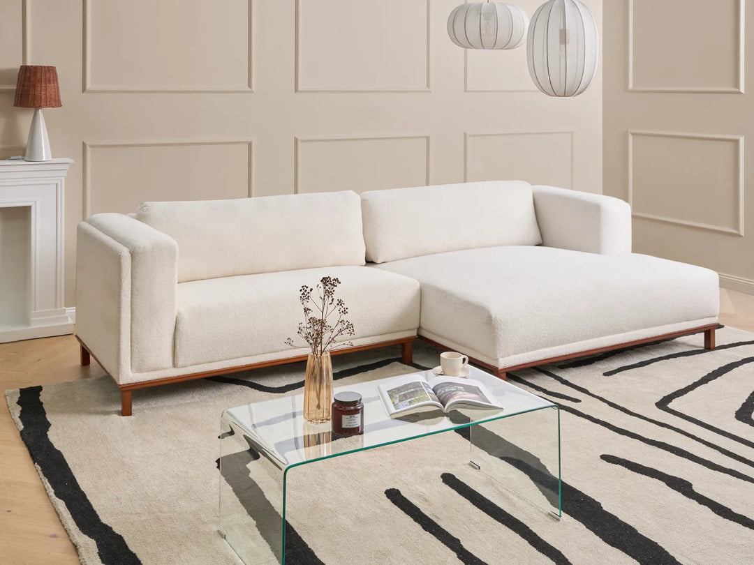 4-seater off-white bouclé corner sofa left orientation with soft textured upholstery and stable wooden frame